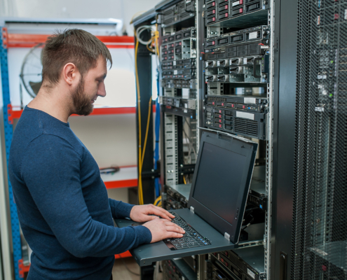 Network engineer working in server room