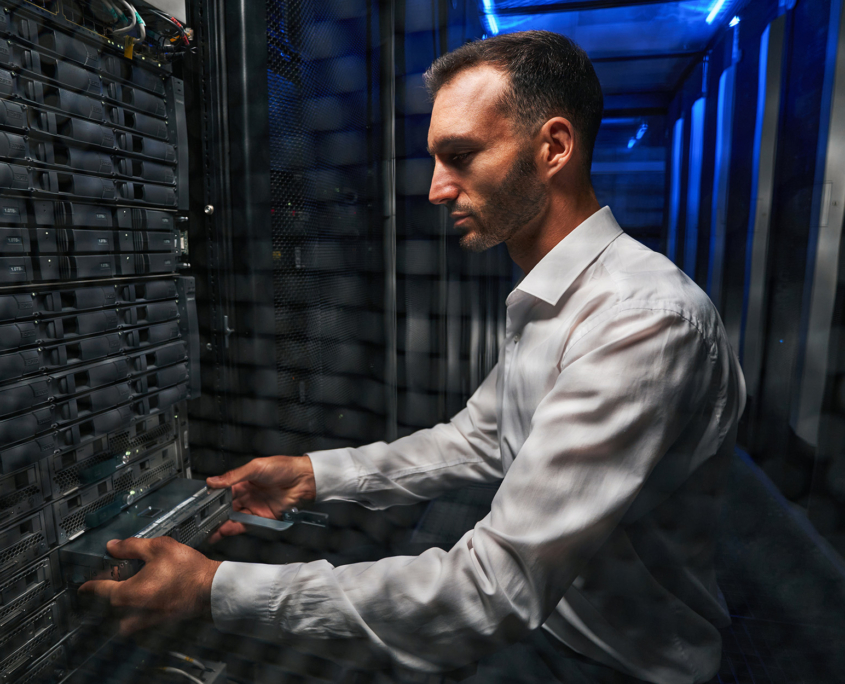 Side view of a IT professional working in a data center