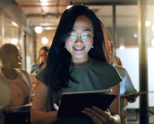 Person walking in office looking at tablet