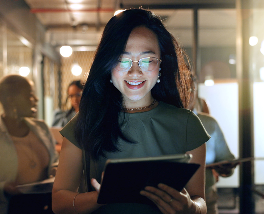 Person walking in office looking at tablet