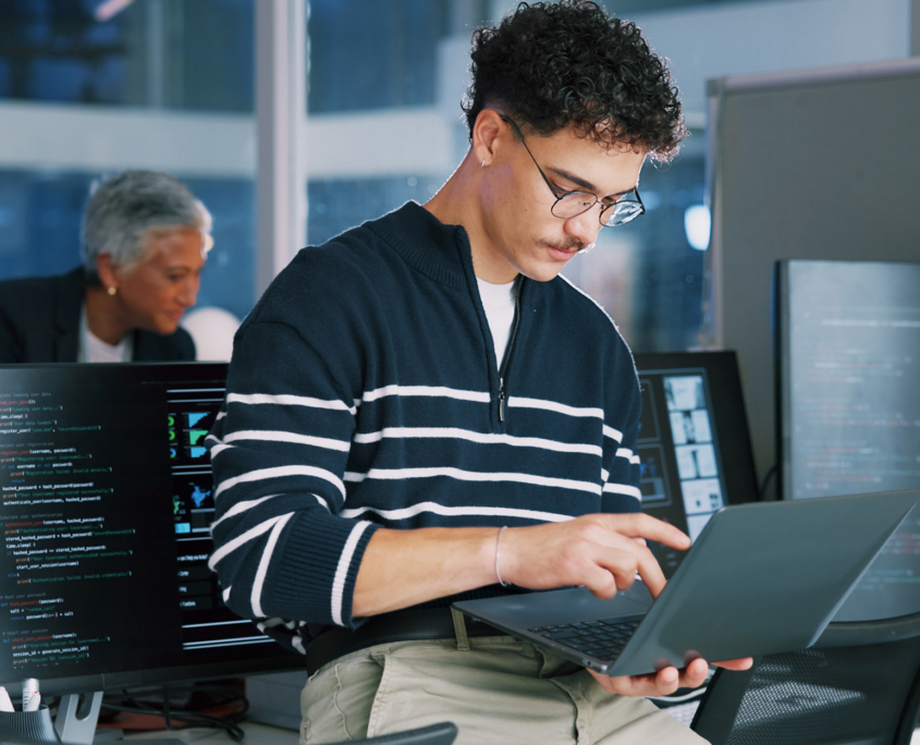Man, programmer and office with laptop for coding, software development or app design Man, programmer and office with laptop for coding, software development or app design